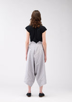 A model wears the 132 5. ISSEY MIYAKE NO.2 trousers.