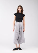 A model wears the 132 5. ISSEY MIYAKE NO.2 trousers.