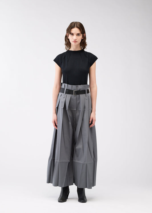 A model wears the 132 5. ISSEY MIYAKE NO.3 trousers.