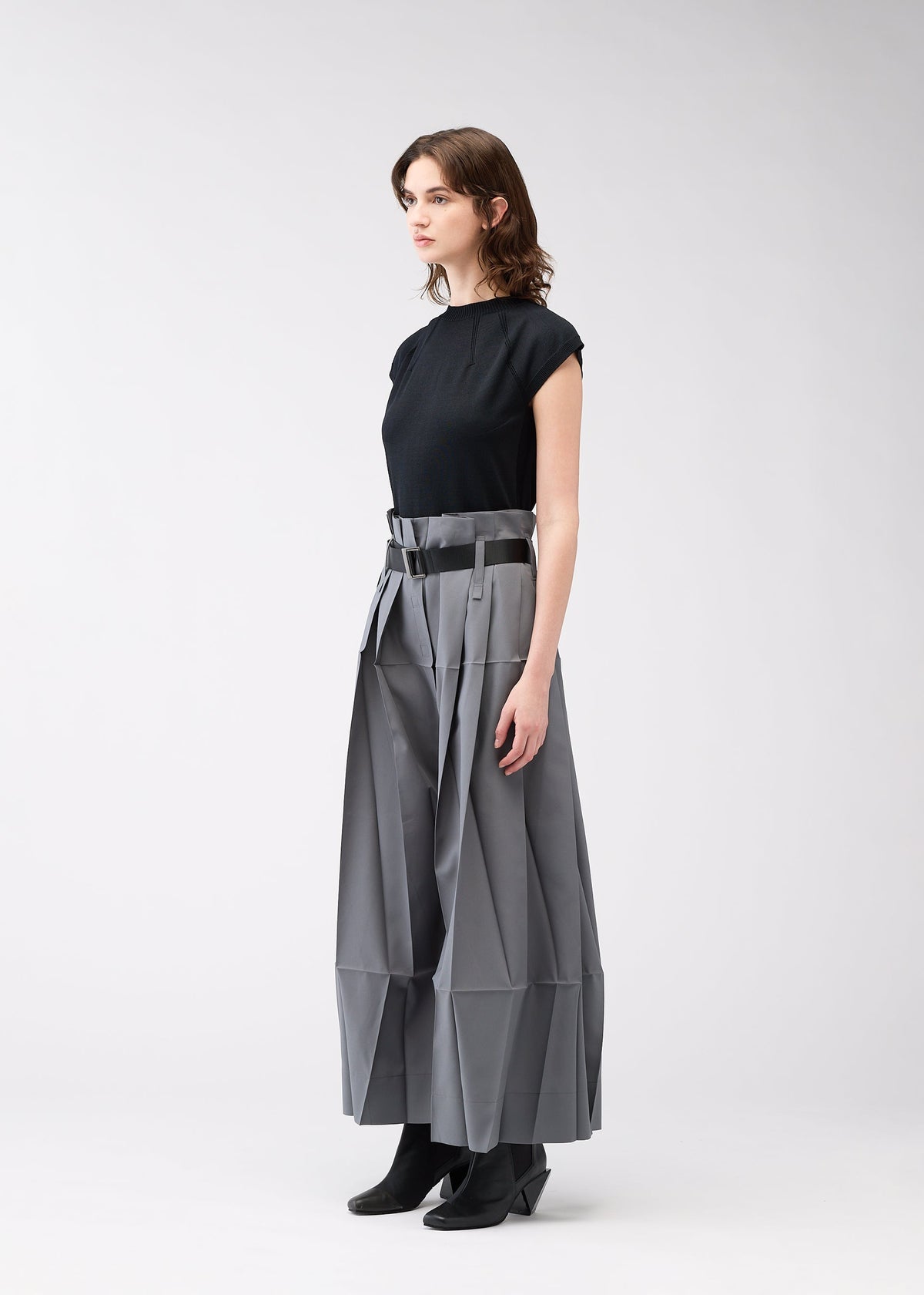 A model wears the 132 5. ISSEY MIYAKE NO.3 trousers.