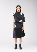A model wears the 132 5. ISSEY MIYAKE POSITIONS dress.