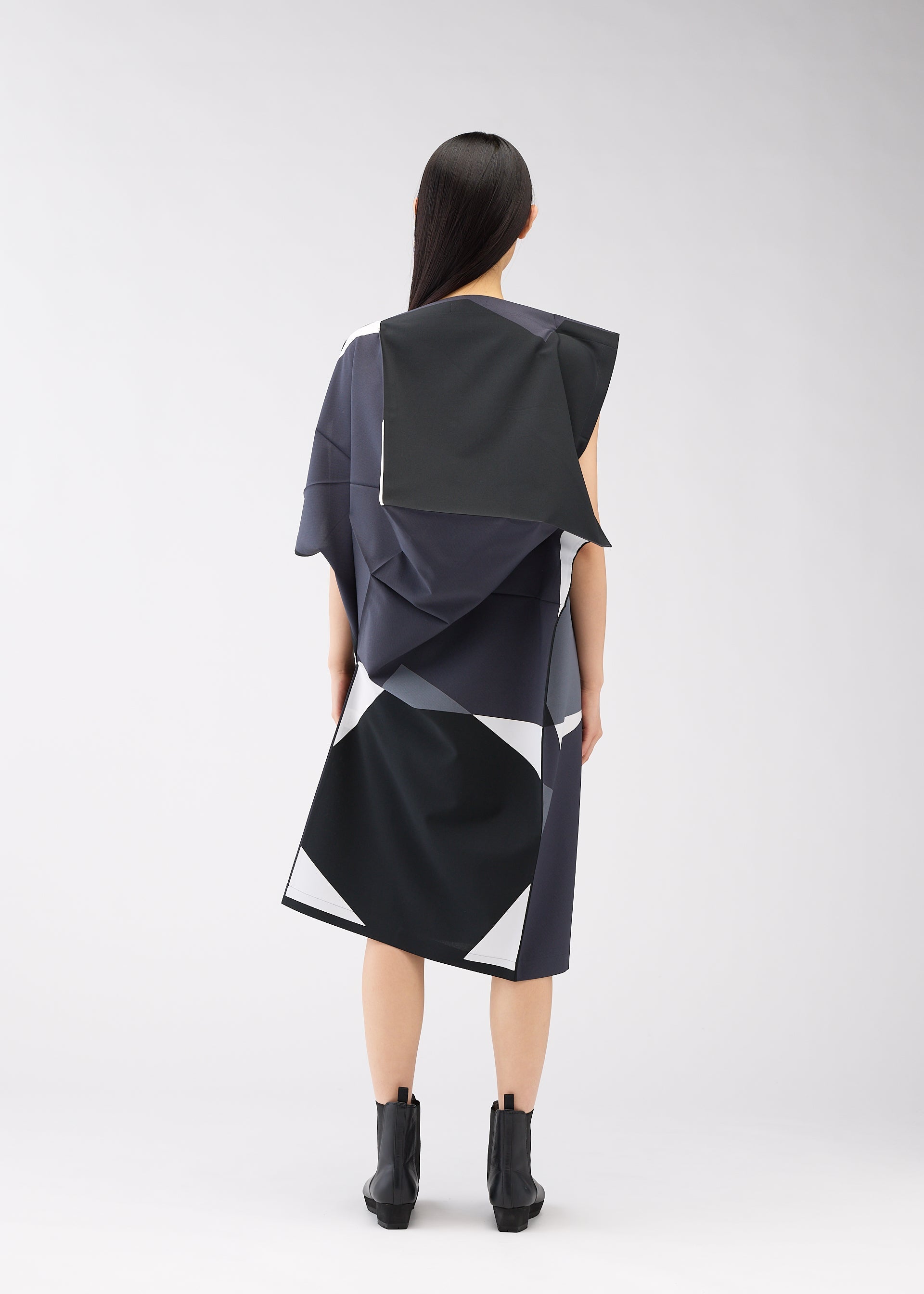 A model wears the 132 5. ISSEY MIYAKE POSITIONS dress.