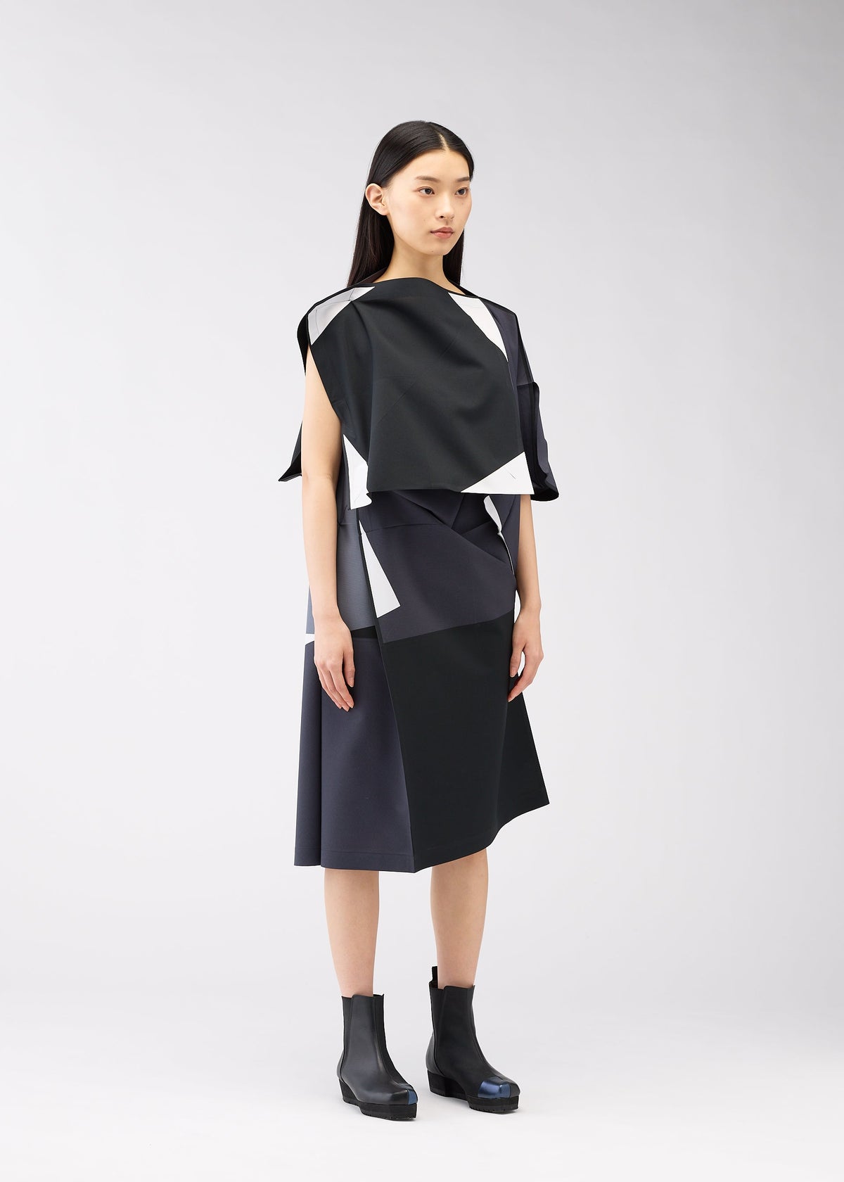 A model wears the 132 5. ISSEY MIYAKE POSITIONS dress.