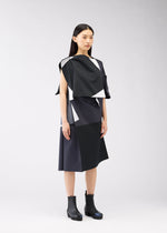 A model wears the 132 5. ISSEY MIYAKE POSITIONS dress.
