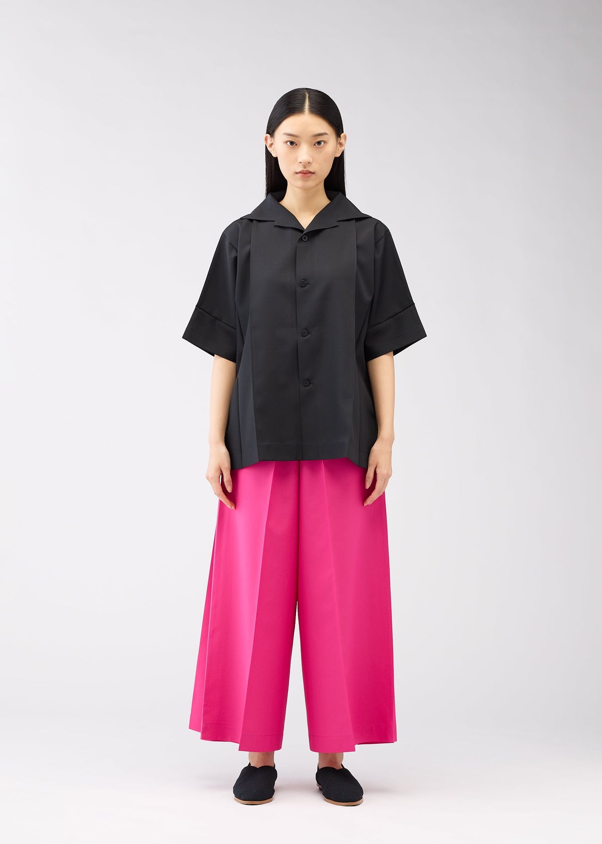 A model wears the 132 5. ISSEY MIYAKE FLAT SHIRTS shirt.