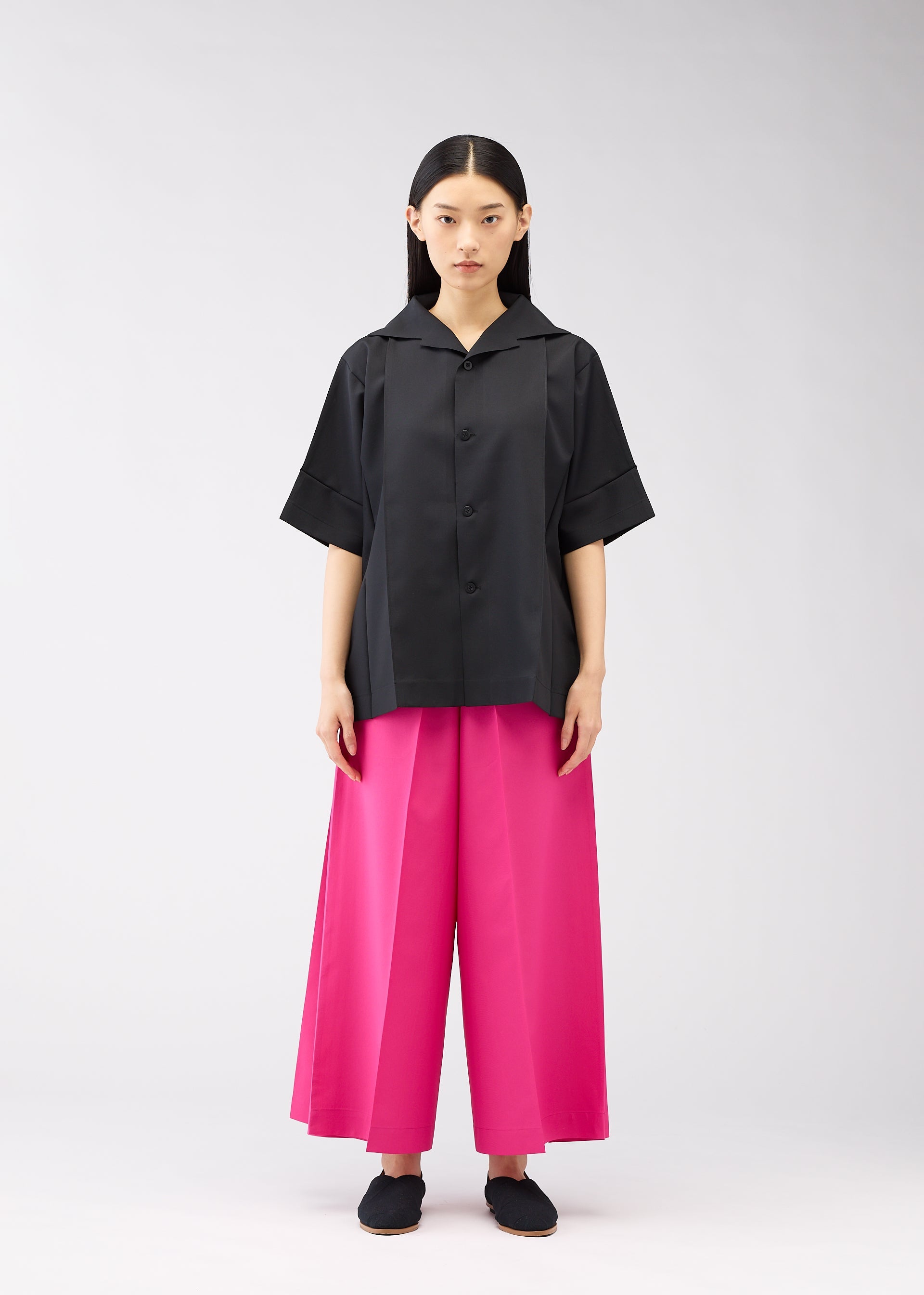 A model wears the 132 5. ISSEY MIYAKE FLAT SHIRTS shirt.