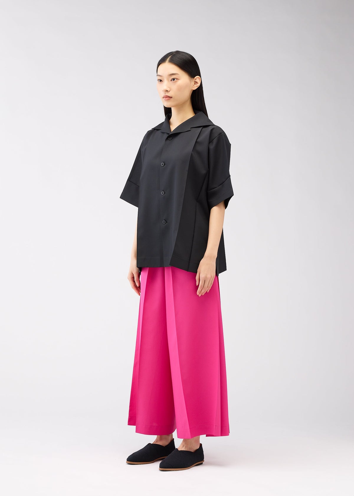 A model wears the 132 5. ISSEY MIYAKE FLAT SHIRTS shirt.