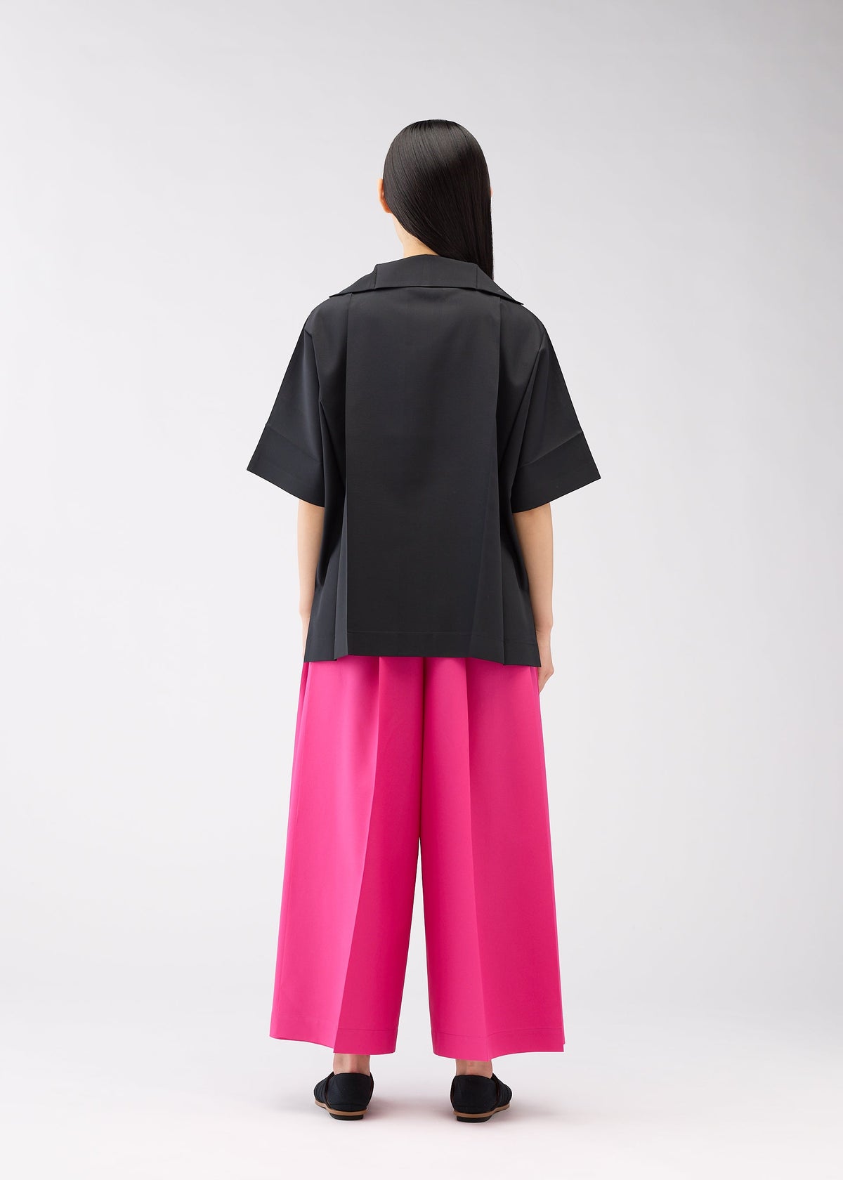 A model wears the 132 5. ISSEY MIYAKE FLAT SHIRTS shirt.