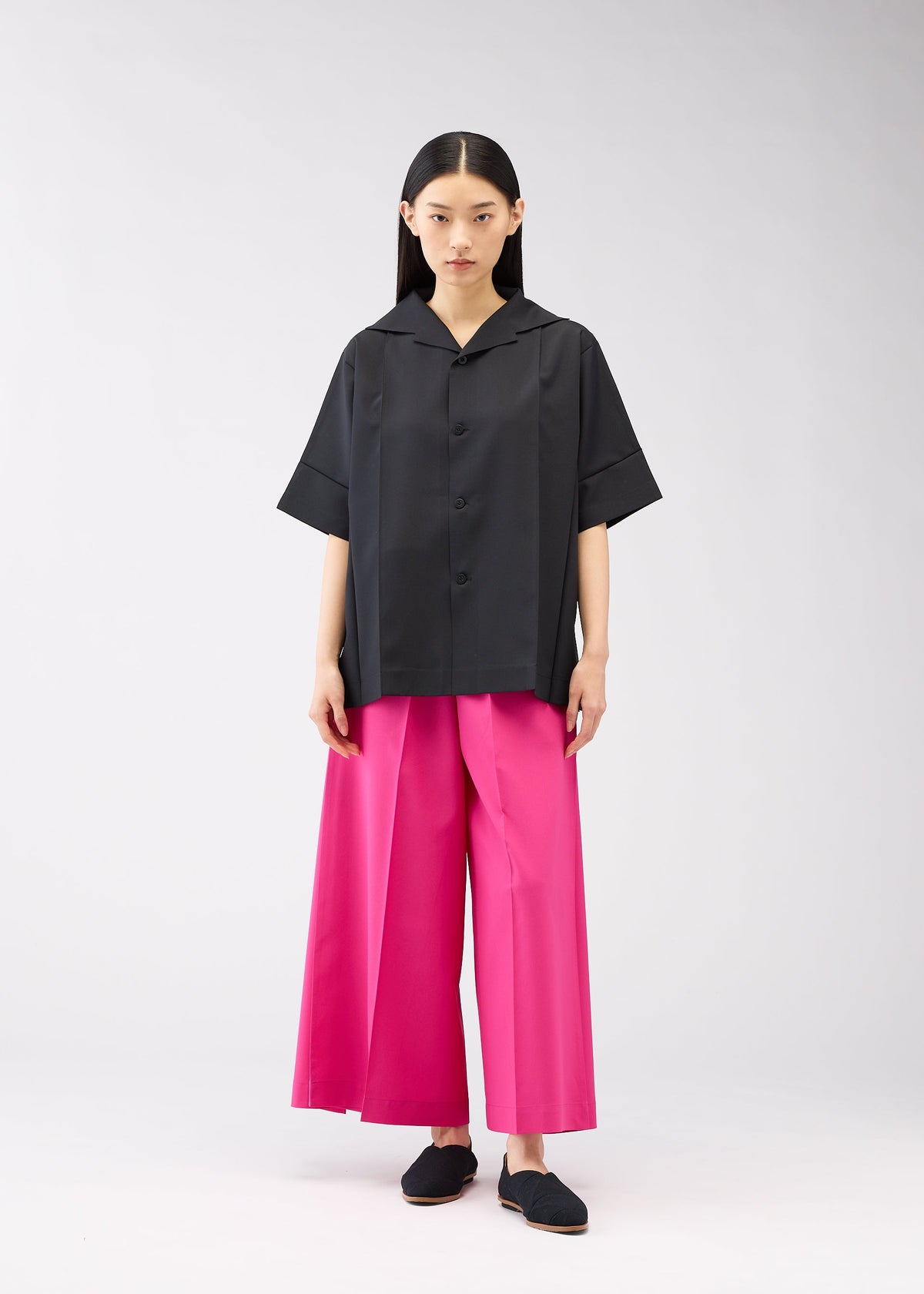 A model wears the 132 5. ISSEY MIYAKE FLAT SHIRTS shirt.