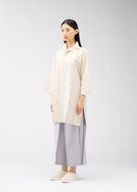 A model wears the 132 5. ISSEY MIYAKE FLAT SHIRTS shirt.