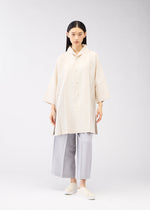 A model wears the 132 5. ISSEY MIYAKE FLAT SHIRTS shirt.