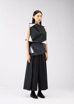 A model wears the 132 5. ISSEY MIYAKE POSITIONS shirt.