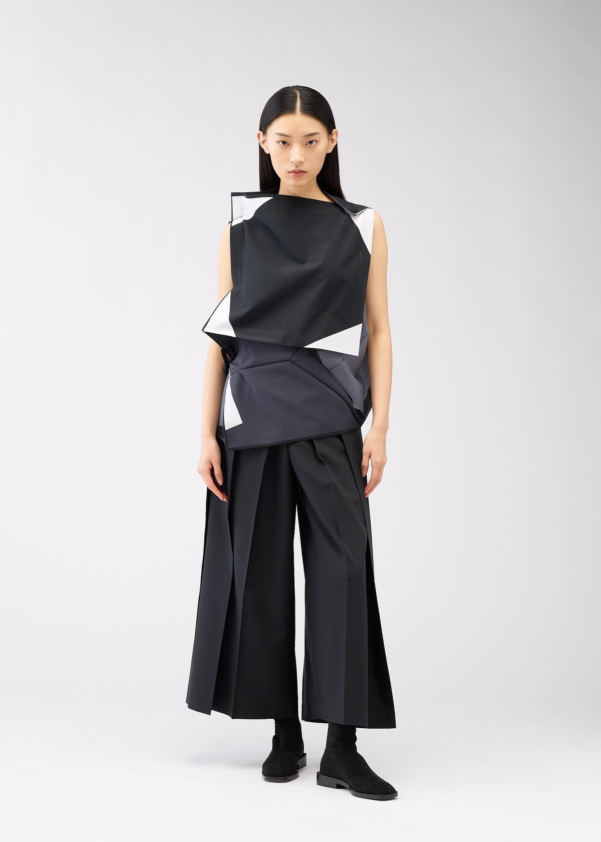 A model wears the 132 5. ISSEY MIYAKE POSITIONS shirt.
