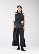 A model wears the 132 5. ISSEY MIYAKE POSITIONS shirt.