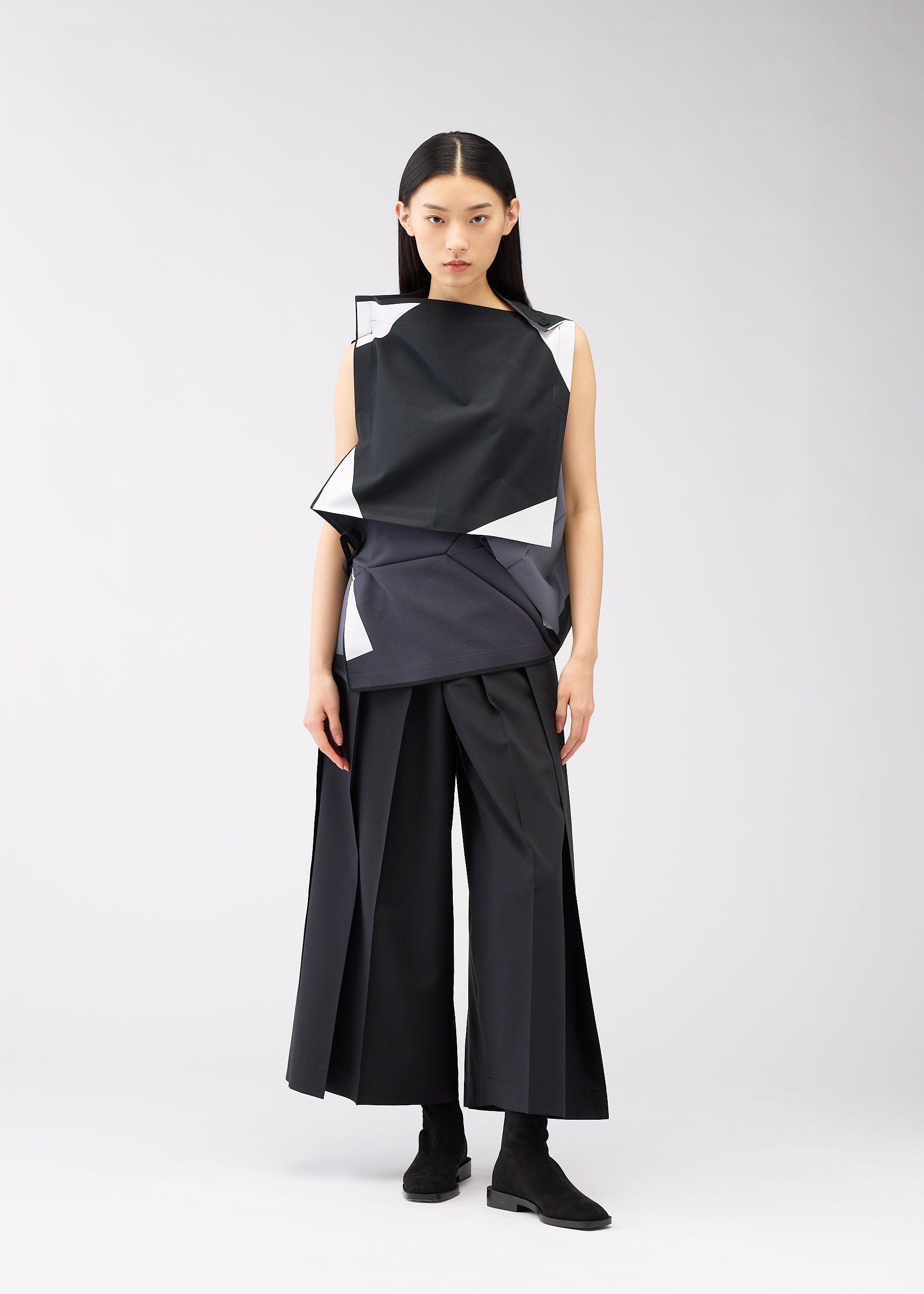 A model wears the 132 5. ISSEY MIYAKE POSITIONS shirt.