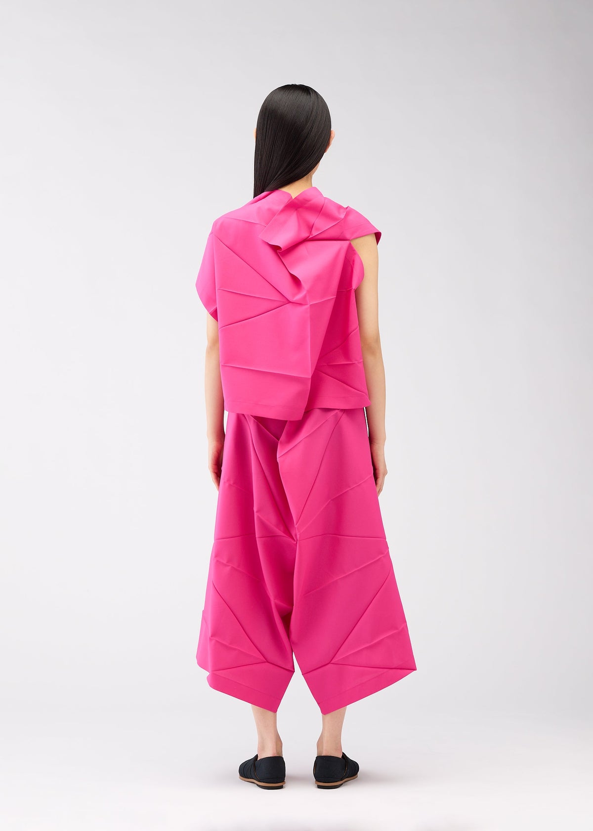 A model wears the 132 5. ISSEY MIYAKE NO.2 shirt.