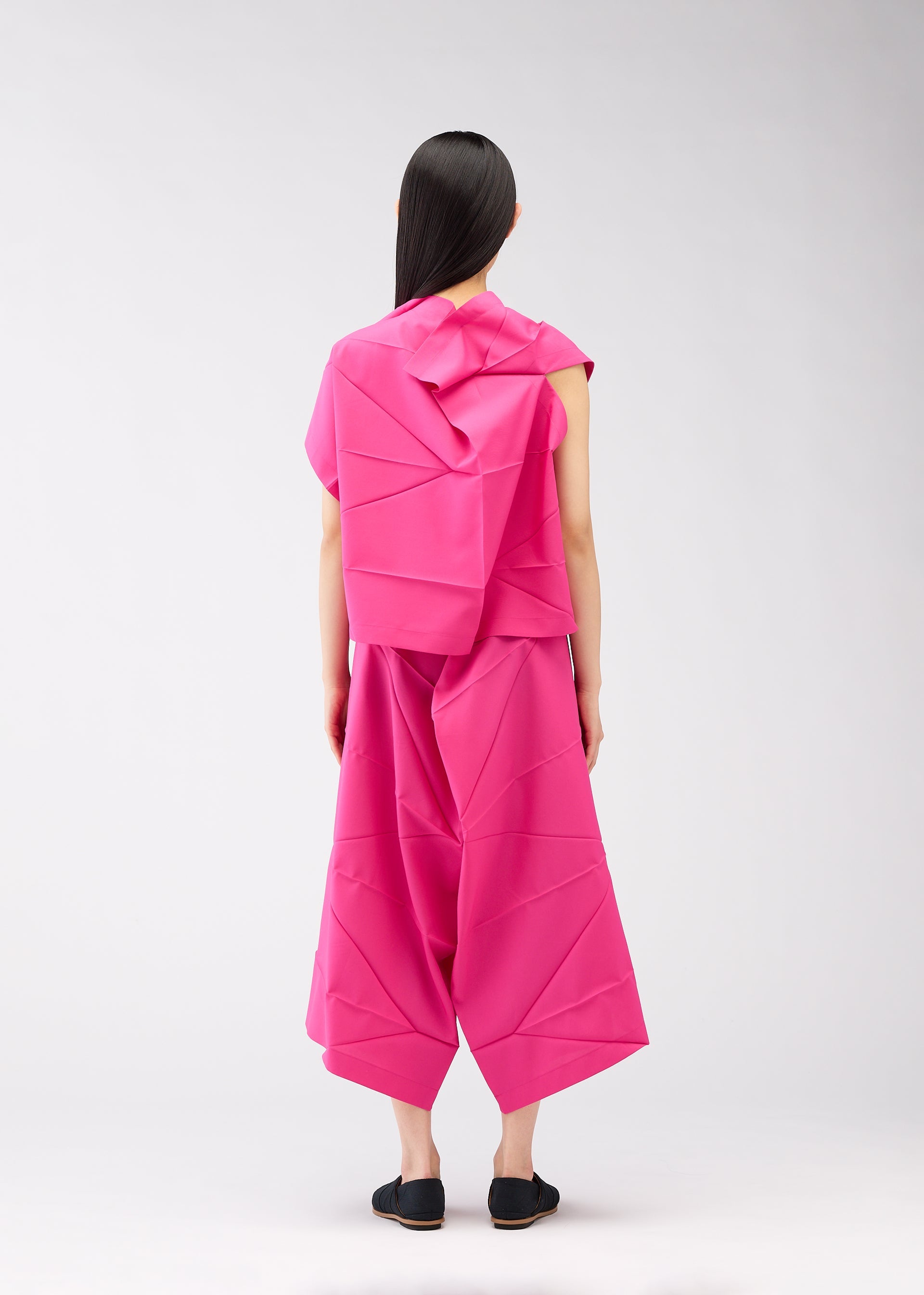 A model wears the 132 5. ISSEY MIYAKE NO.2 shirt.