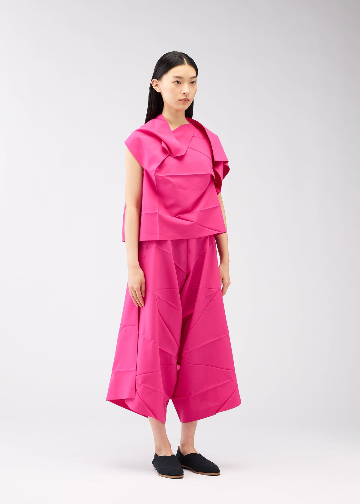 A model wears the 132 5. ISSEY MIYAKE NO.2 shirt.