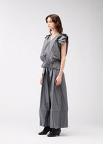 A model wears the 132 5. ISSEY MIYAKE NO.3 shirt.