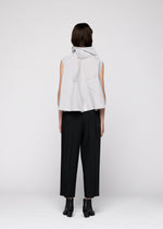 A model wears the 132 5. ISSEY MIYAKE NO.16 FOIL shirt.