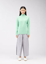 A model wears the 132 5. ISSEY MIYAKE DARTED KNIT top.
