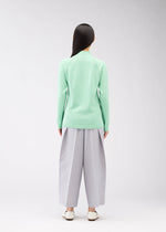 A model wears the 132 5. ISSEY MIYAKE DARTED KNIT top.