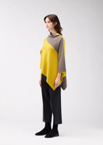 A model wears the 132 5. ISSEY MIYAKE POSITIONED KNIT top.