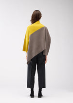A model wears the 132 5. ISSEY MIYAKE POSITIONED KNIT top.