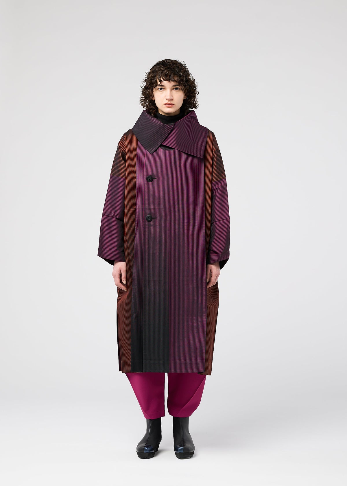 A model wears the 132 5. ISSEY MIYAKE GRADATION COAT clothing.