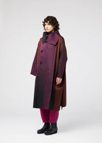 A model wears the 132 5. ISSEY MIYAKE GRADATION COAT clothing.