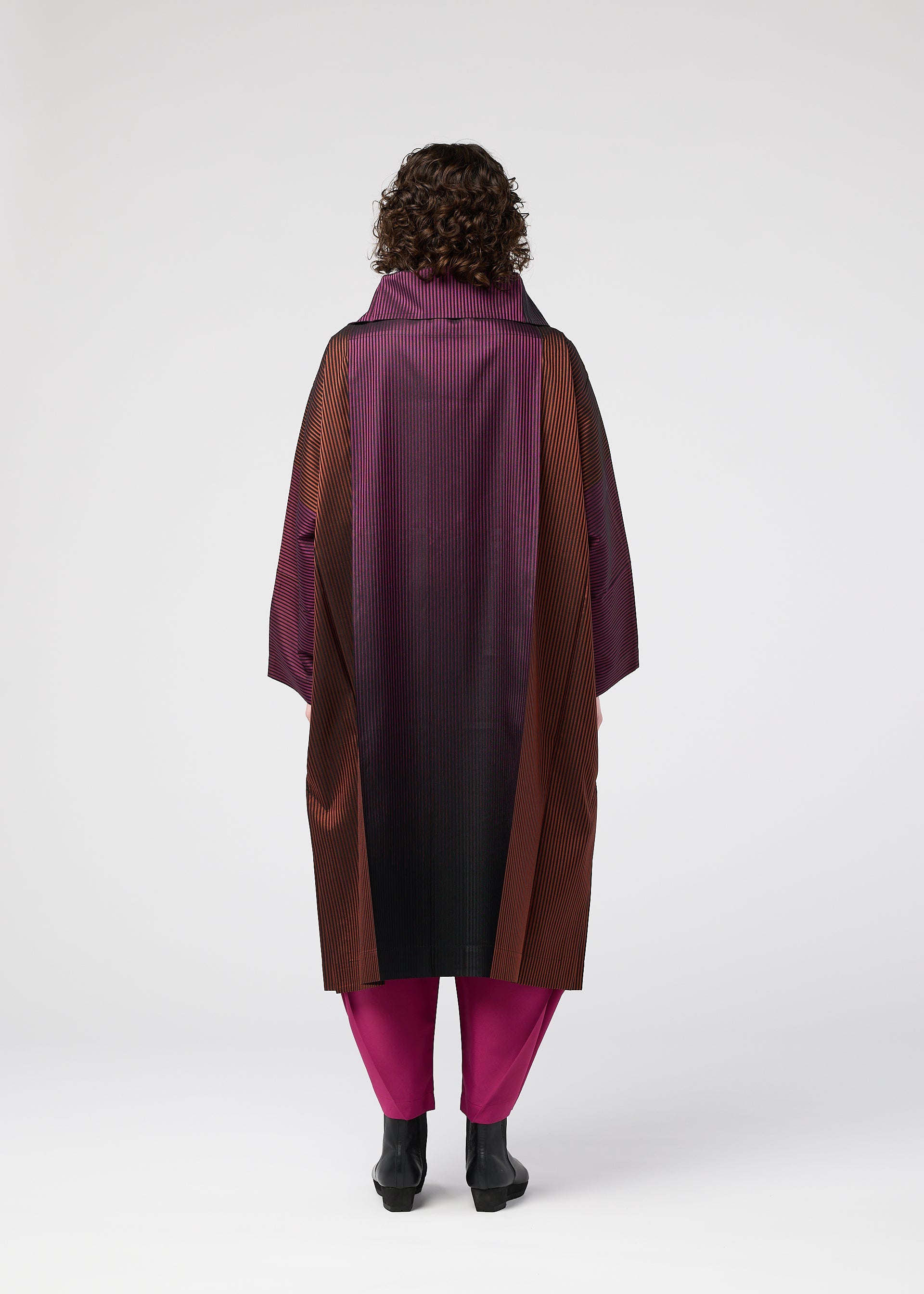 A model wears the 132 5. ISSEY MIYAKE GRADATION COAT clothing.