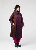A model wears the 132 5. ISSEY MIYAKE GRADATION COAT clothing.