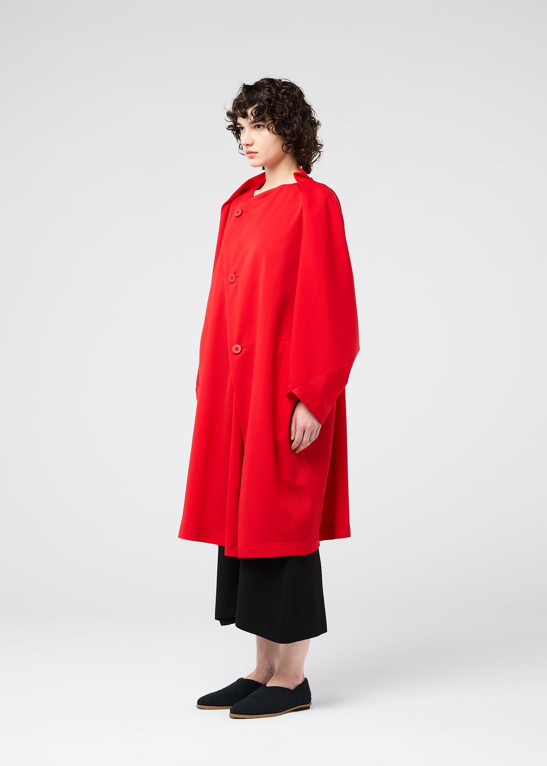 A model wears the 132 5. ISSEY MIYAKE PARALLEL WRAP coat.