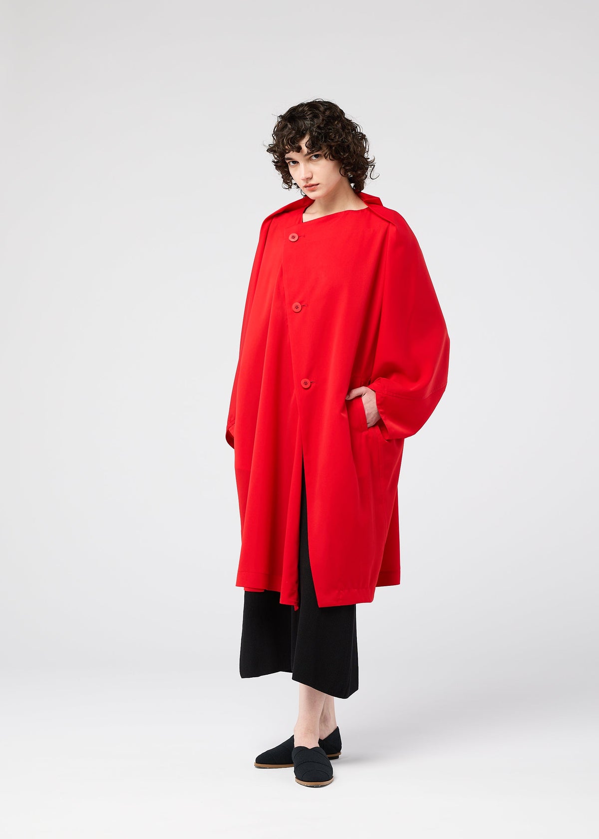 A model wears the 132 5. ISSEY MIYAKE PARALLEL WRAP coat.