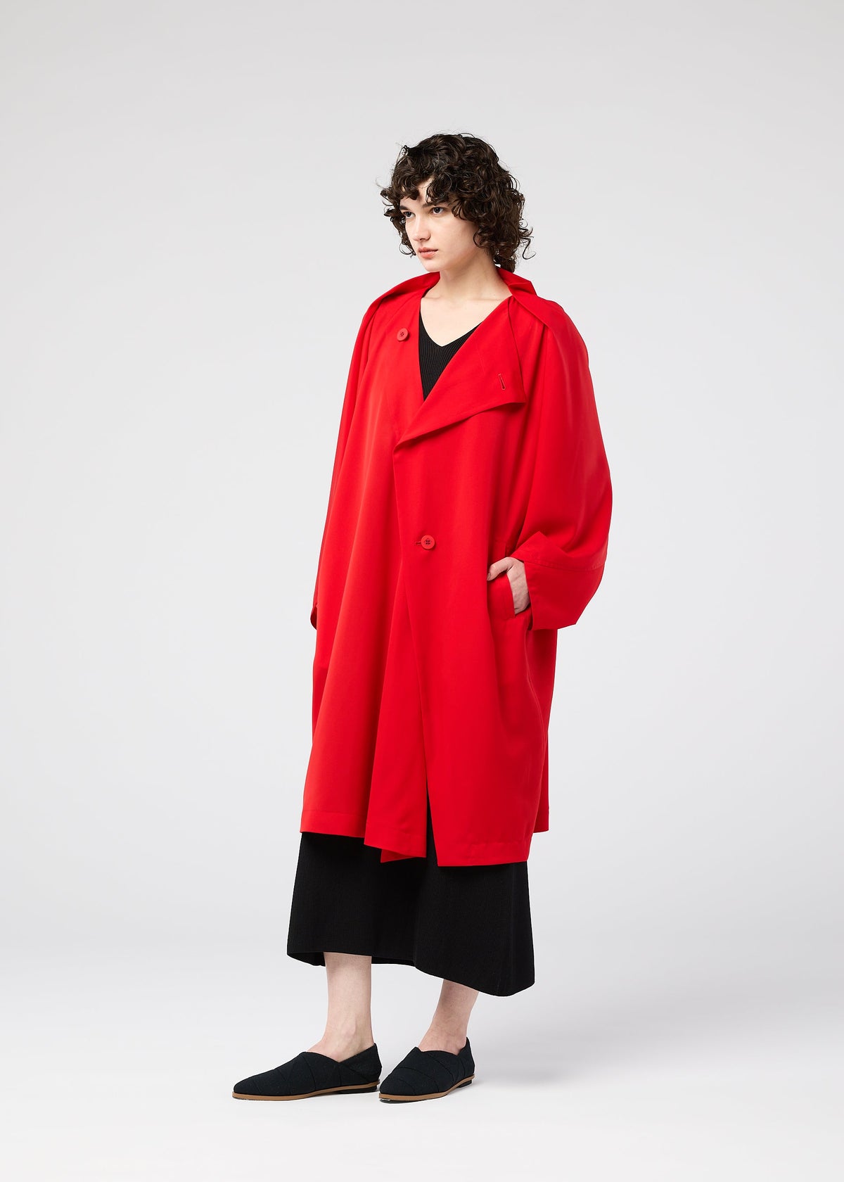 A model wears the 132 5. ISSEY MIYAKE PARALLEL WRAP coat.