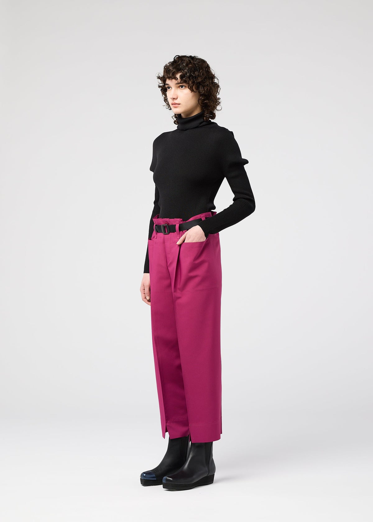 A model wears the 132 5. ISSEY MIYAKE 132 5. FLAT 1 trousers.