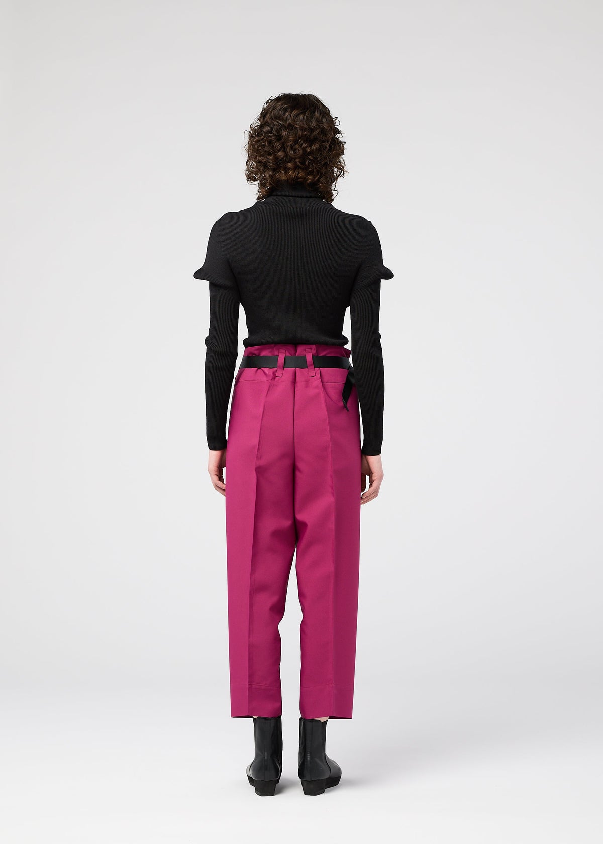 A model wears the 132 5. ISSEY MIYAKE 132 5. FLAT 1 trousers.