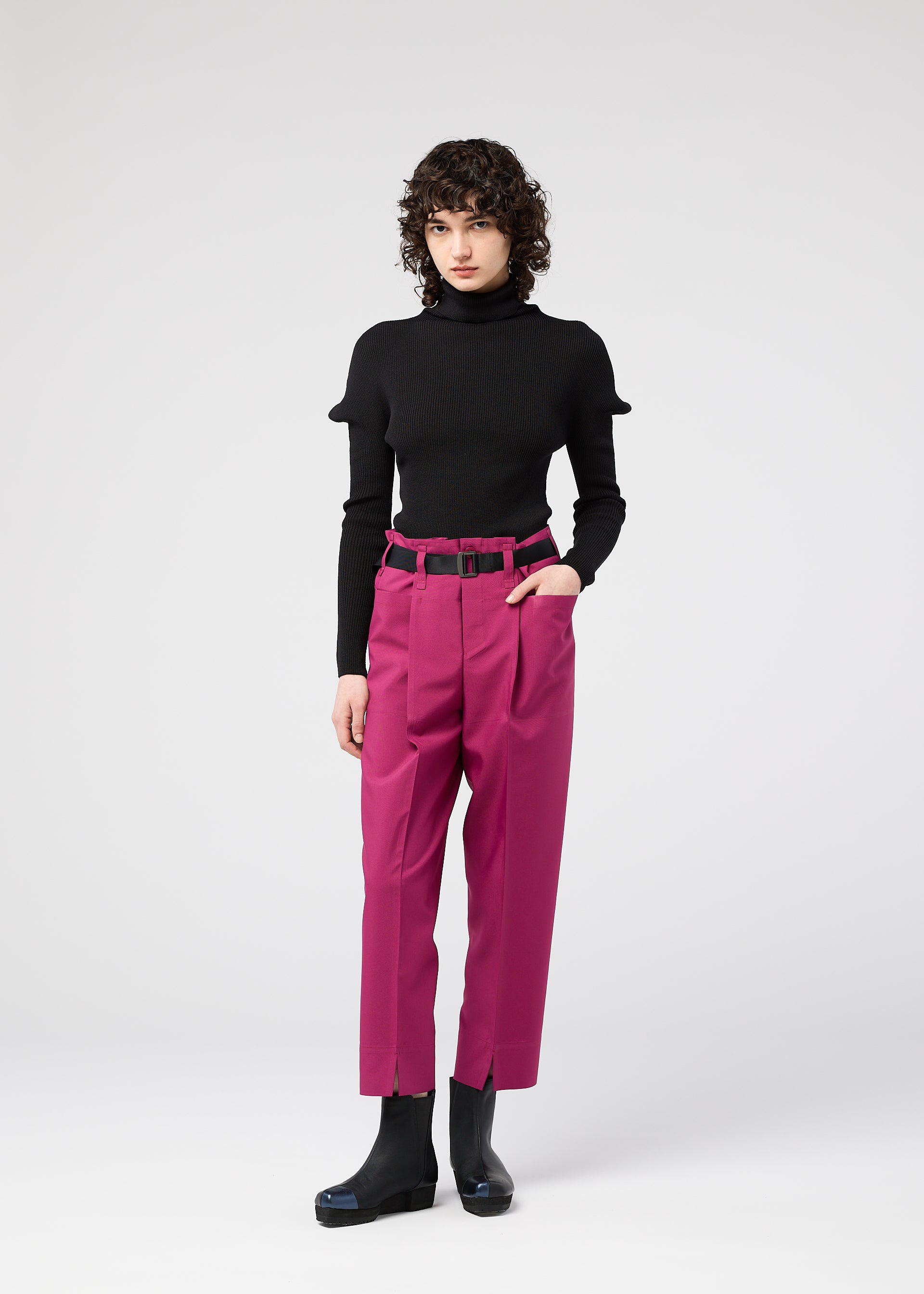 A model wears the 132 5. ISSEY MIYAKE 132 5. FLAT 1 trousers.