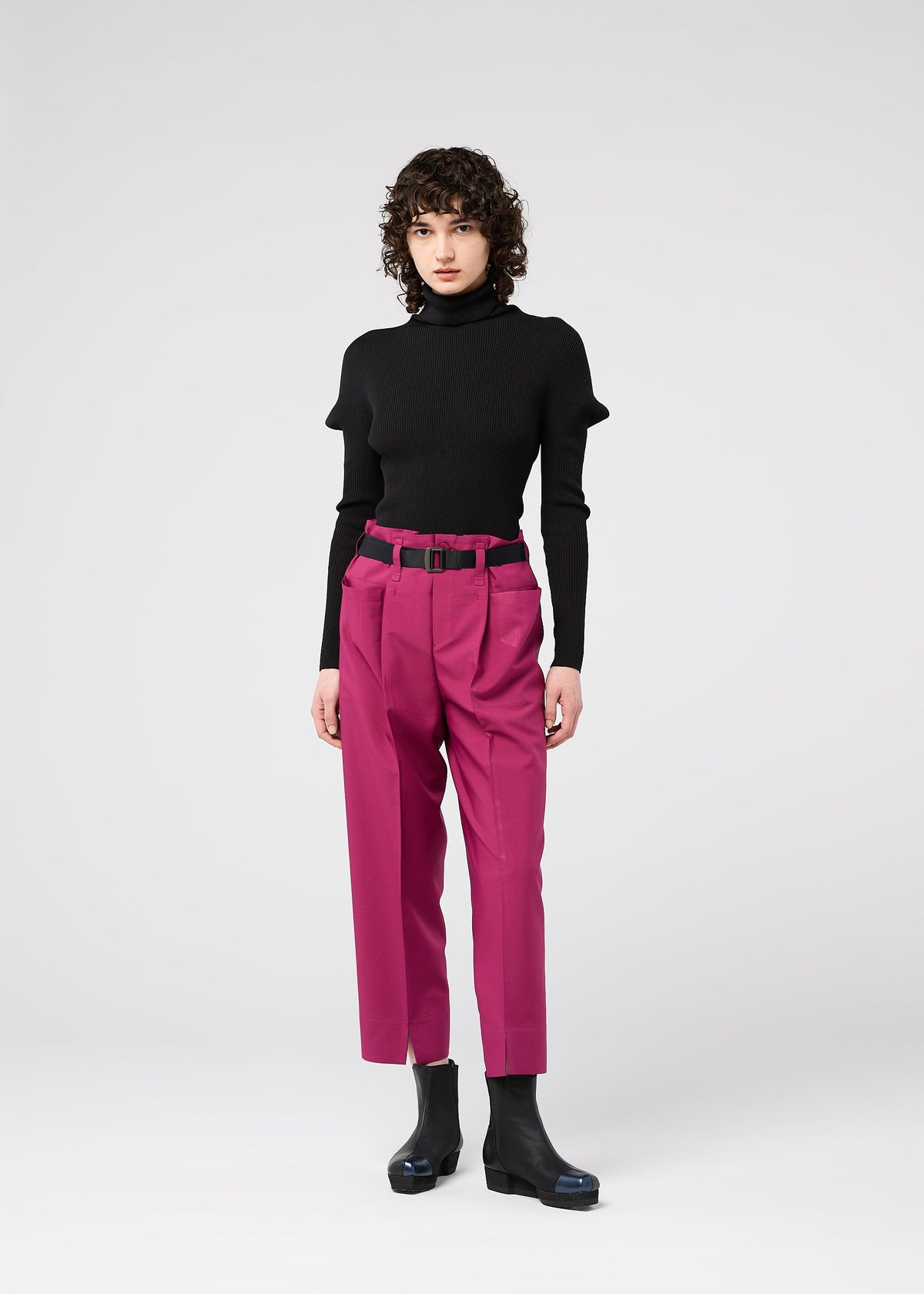 A model wears the 132 5. ISSEY MIYAKE 132 5. FLAT 1 trousers.