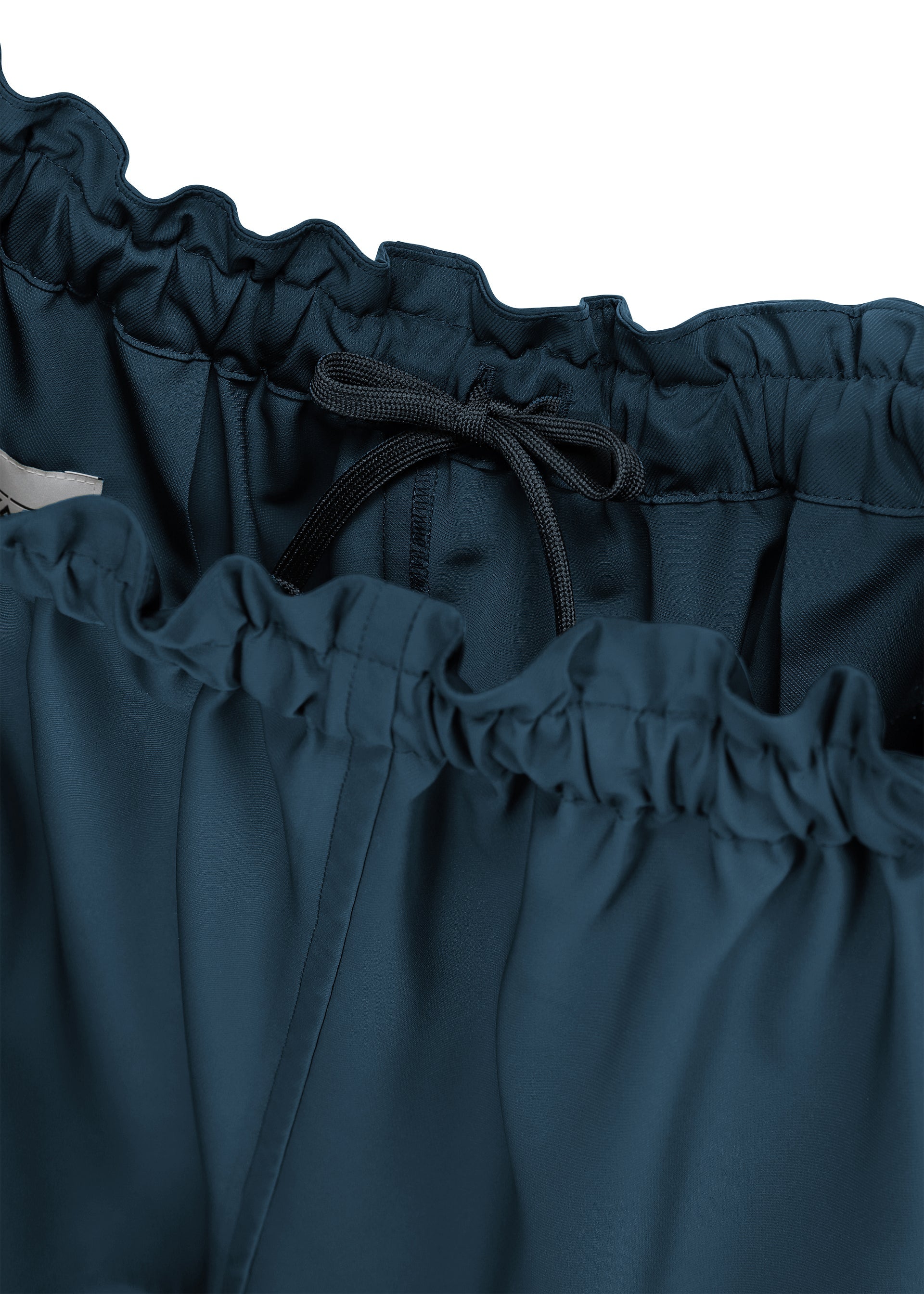 A detail shot of the 132 5. ISSEY MIYAKE PARALLEL WRAP trousers.