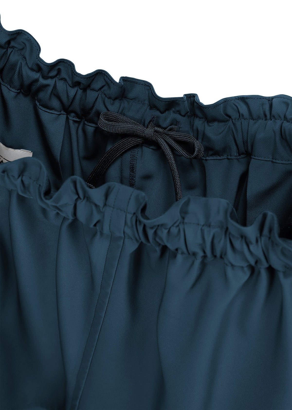 A detail shot of the 132 5. ISSEY MIYAKE PARALLEL WRAP trousers.