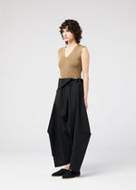 A model wears the 132 5. ISSEY MIYAKE FACET SOLID trousers.
