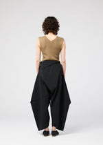 A model wears the 132 5. ISSEY MIYAKE FACET SOLID trousers.