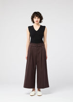 A model wears the 132 5. ISSEY MIYAKE WASHI STRETCH trousers.