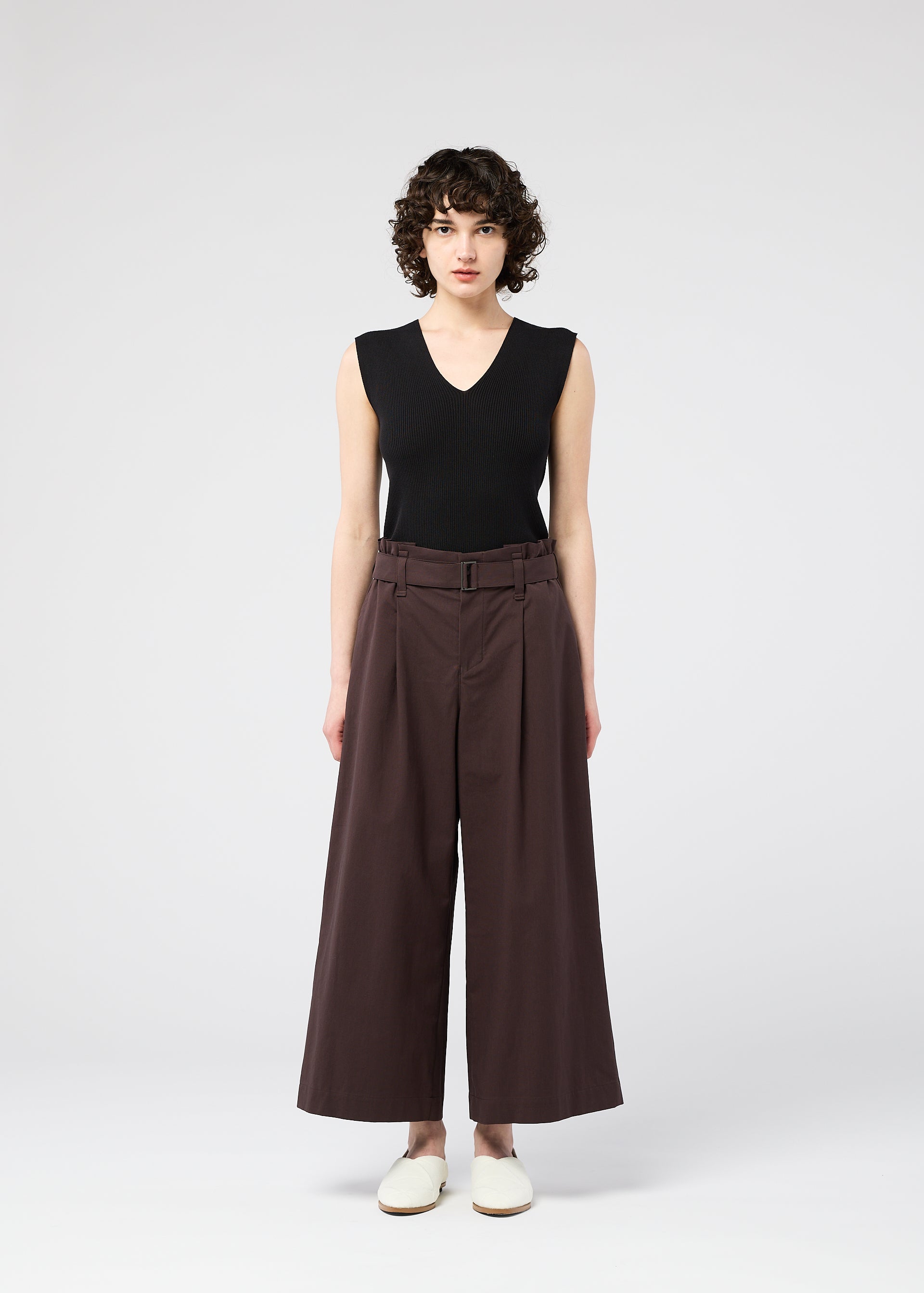 A model wears the 132 5. ISSEY MIYAKE WASHI STRETCH trousers.