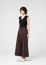 A model wears the 132 5. ISSEY MIYAKE WASHI STRETCH trousers.