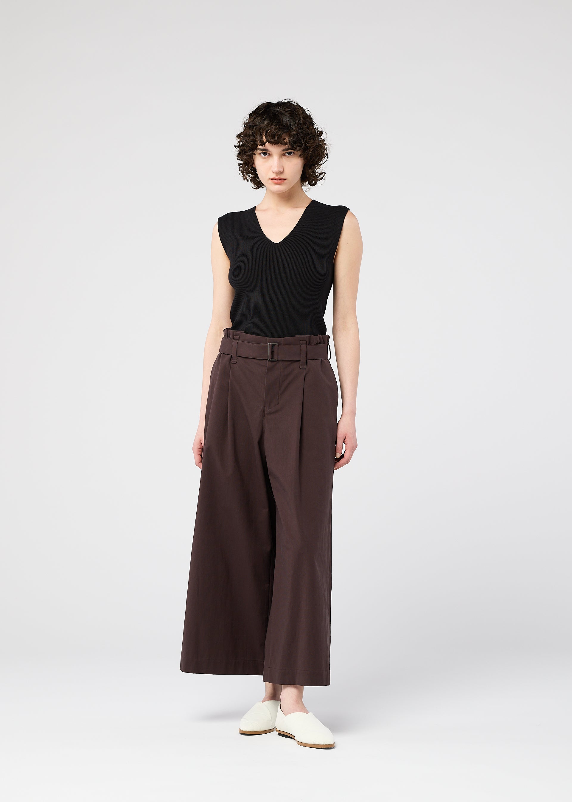 A model wears the 132 5. ISSEY MIYAKE WASHI STRETCH trousers.
