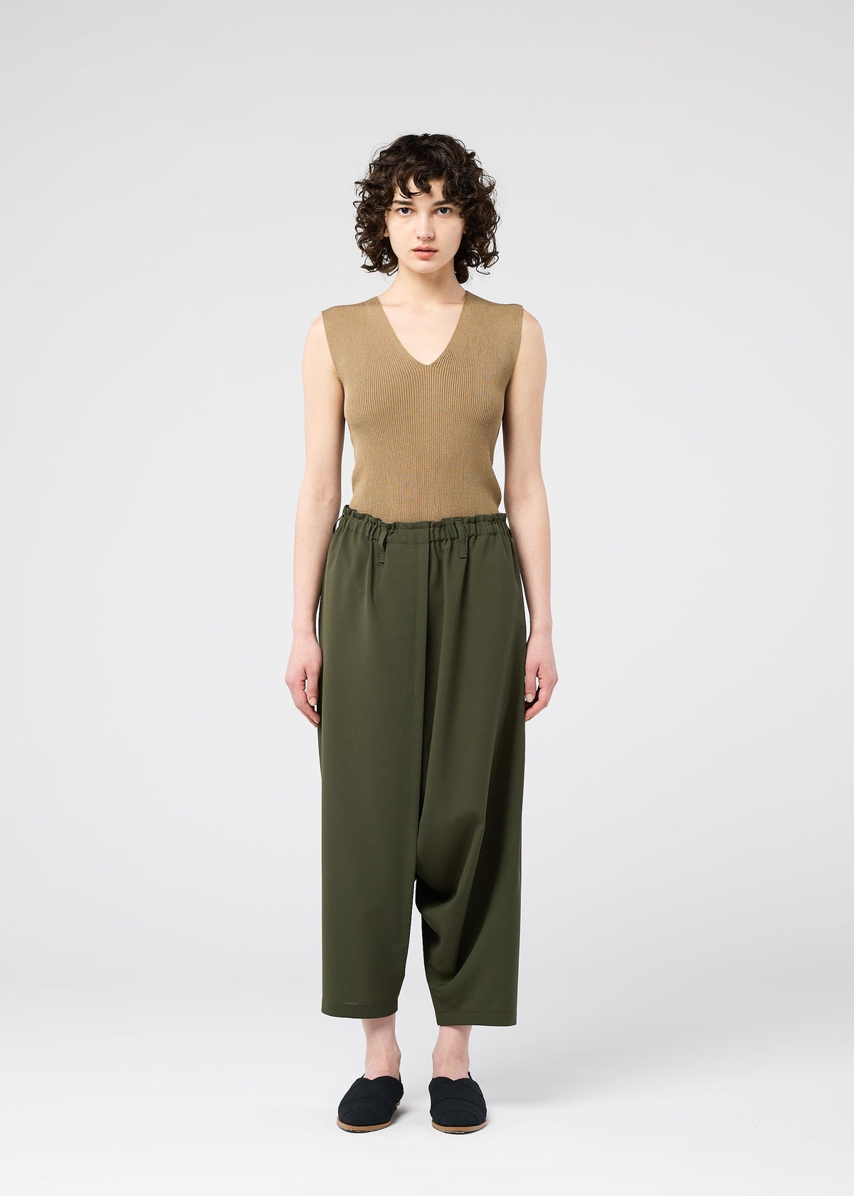 A model wears the 132 5. ISSEY MIYAKE SEAMLESS trousers.