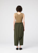 A model wears the 132 5. ISSEY MIYAKE SEAMLESS trousers.