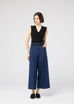 A model wears the 132 5. ISSEY MIYAKE 132 5. FLAT 2 trousers.